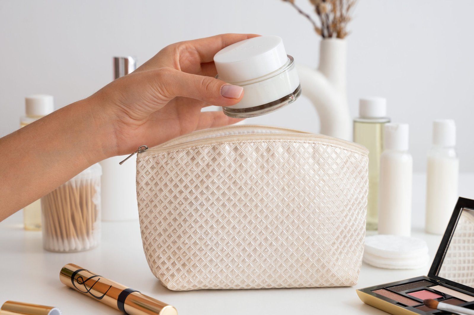 side-view-hand-holding-cream-container